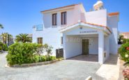 Charming Paphos villa with terracotta roof, solar water heater, and lush landscaping in Roza-01.