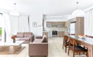 Modern and spacious Paphos Villa with open-plan living and kitchen area with minimalist design and cozy seating.