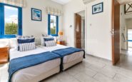 Kissonerga Villa with Bright and inviting twin bedroom with coastal decor and natural light.