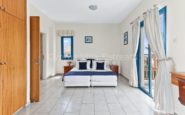 Kissonerga Villa with Bright and airy double bedroom with white and blue colour scheme.