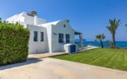 Luxurious white villas in Cyprus Paphos by the coast with Mediterranean architecture and stunning ocean views.