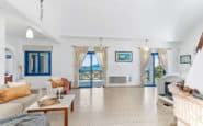 Holiday villas on paphos with Bright and airy living room with blue accents, cozy seating, and fireplace.