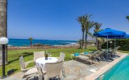 Luxurious outdoor patio with pool and sea view, perfect for relaxing vacations.