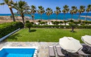 Villa for rent with stunning coastal views and pool with lush palm trees and ocean view.