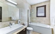 Villas for rent with Modern and stylish bathroom with neutral tones, sleek fixtures, and functional layout.