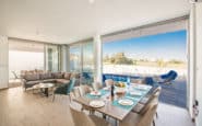 Holiday rentals in Cyprus Protaras with open-plan dining and living area with modern decor and outdoor view.