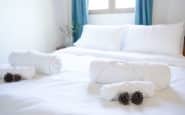 Fresh bedroom setup at Villa Aura, Nicosia with white linens and pinecones