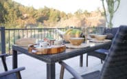 Outdoor dining area at Villa Aura, Nicosia with a view of the surrounding hills