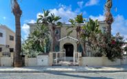 Beautiful Mediterranean-style two-story villa with lush garden and arched entrance in Kato Paphos