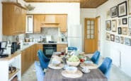 Kitchen and dining space at Villa Aura in Nicosia with framed pictures on the wall