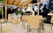 Covered patio with seating at Villa Aura in Nicosia featuring a barbecue grilll