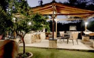 Outdoor barbecue and dining area at Villa Aura, with a covered patio