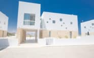 Cyprus Villa Rentals with Modern minimalist residential buildings with clean lines and white facades in Protaras, Cyprus.