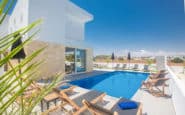 Cyprus Villa Rentals with Luxurious modern outdoor pool area with minimalist design and comfortable seating options.