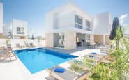 Luxurious modern villa with pool, sun loungers, and outdoor dining area Cyprus Villa Rentals in Protaras, Cyprus.