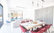 Modern dining and living area with elegant furniture, natural light, and stylish decor in Cyprus Villa Rentals