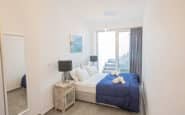 Modern and cozy double bedroom in Cyprus villa rental with minimalist design and tranquil ambiance.