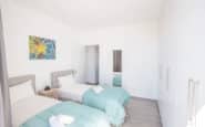 Luxurious twin bedroom with modern design and serene atmosphere in Protaras villa.