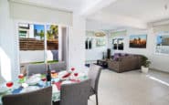 Modern open-plan living and dining area in a stylish villa rental in Protaras, Cyprus.