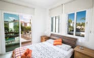 Modern minimalist bedroom with balcony in Protaras holiday villa.