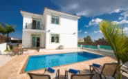 Luxurious villa with pool, sunbeds, and trees for rental in Protaras.