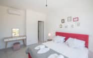 Modern minimalist bedroom with pink bed in Villa Alfredo, Protaras for rent.