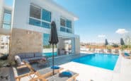 Luxurious modern villa with outdoor pool area and stylish furniture in Cyprus.