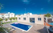 Modern flat-roofed house with swimming pool in serene residential setting in Protaras.