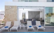 Cyprus Protaras Villa Rentals with modern and stylish outdoor living space, pool, lounge chairs, and elegant interior design.