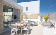 Luxurious outdoor dining area with pool and lounge chairs at Cyprus Protaras Villa Rentals.