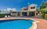 Modern two-story house with swimming pool, deck, and lush greenery in Protaras holiday rental.