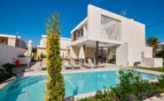 Ayia Napa Villas with pool, blue sky, sun loungers, and lush plants in Ayia Napa