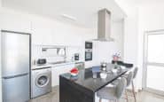 Modern black and white kitchen with breakfast bar and sleek design in Protaras Cyprus.