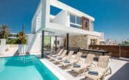 Luxurious modern Ayia Napa Villa with pool, outdoor dining, palm trees, and marina view