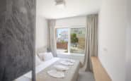 Modern  Ayia Napa Villa with double bedroom with minimalist feel, natural light, and serene view.