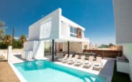 Luxurious modern Ayia Napa villa with pool and outdoor dining in upscale residential area.