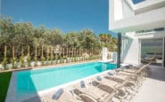 Ayia Napa Villa with poolside setting with modern architecture and serene sunbathing area.