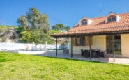 Charming house with lush garden, patio, swimming pool, and trees in the background ideal for Villa Rentals in Protaras.