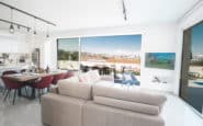 Protaras Holiday Rentals offering luxurious modern open-plan living space with city skyline view and outdoor patio.