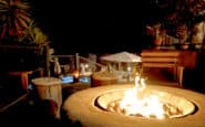 Outdoor fire pit area in Villa Aura, Nicosia with seating and ambient lighting