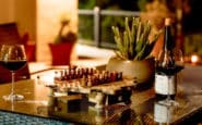 cozy evening setup at Villa Aura Villa in Nicosia with wine and chess on a rustic table