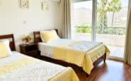 Twin bedroom with Yellow accents at Villa Palms View in Limassol.