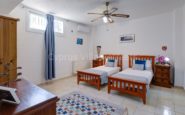 Cyprus Villa Rent with Cozy and organized bedroom with two single beds, dresser, and modern decor.